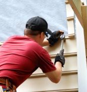 siding contractor installing new vinyl siding on home