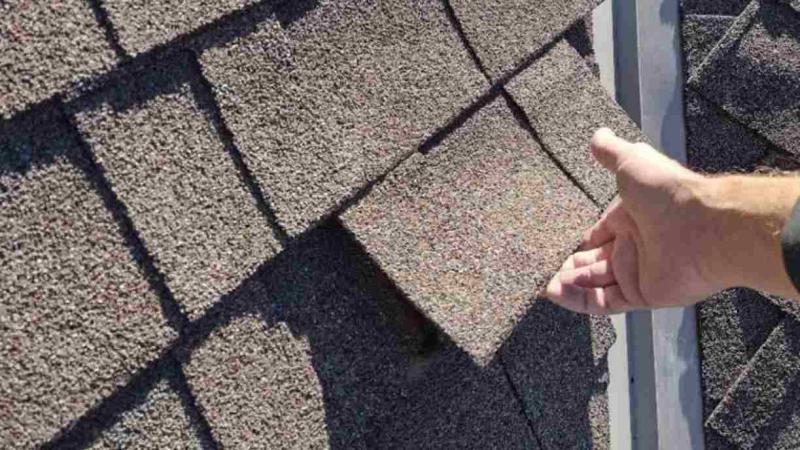 roofer in Norman Oklahoma completing roof inspection after storm