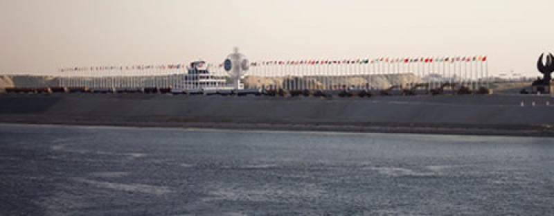 The far side of the Suez Canal was decorated with world flags for the event