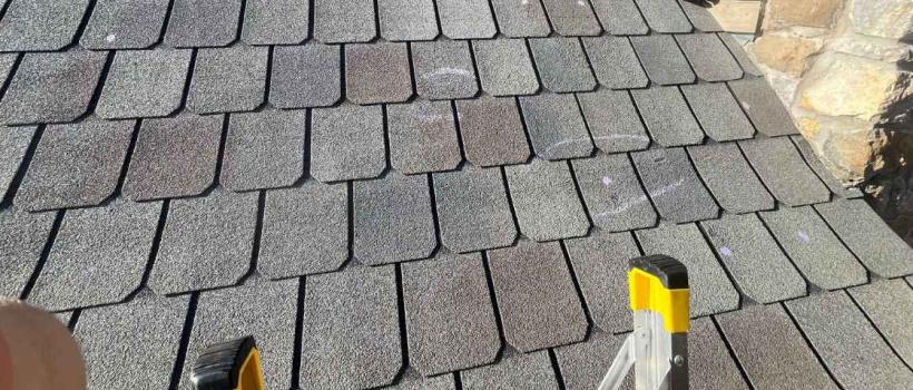 roofer using roof inspection checklist while on home