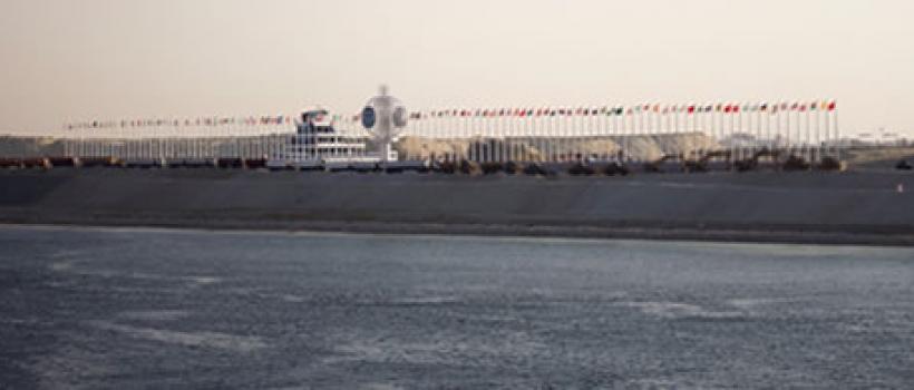 The far side of the Suez Canal was decorated with world flags for the event