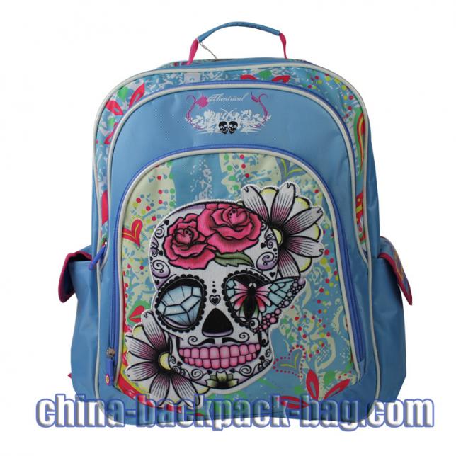 Skull collection backpack. It is designed with blue twill fabric with CMYK printing. Three compartments. The skull is in flannelette printing with embroidery.